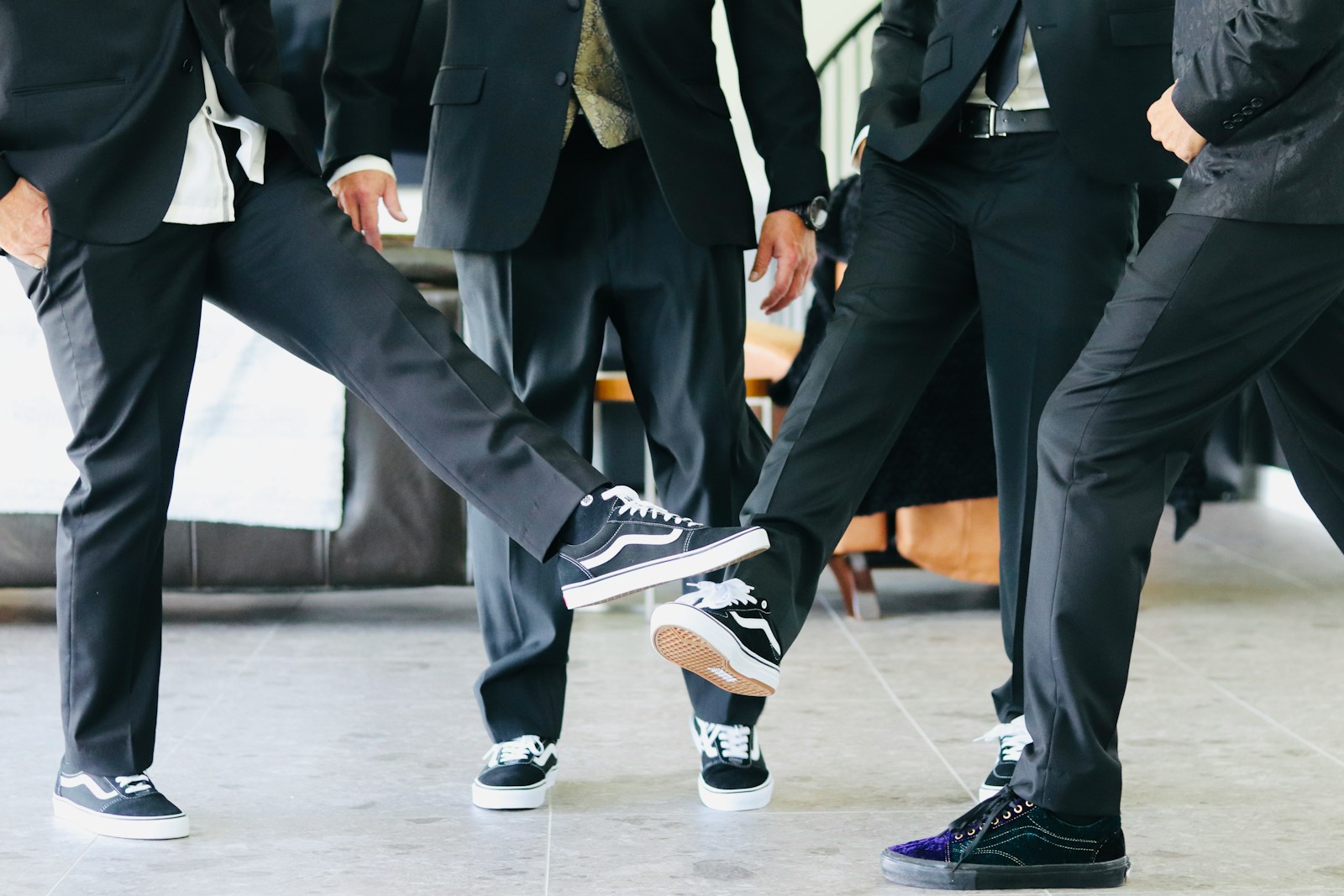 A group of young men in suits and sneakers